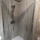 Fully fitted bathroom in Kent with walk-in shower, vanity unit and floor-to-ceiling tiling
