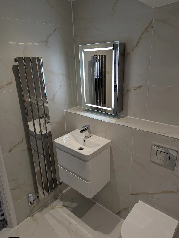 Modern bathroom with LED backlit mirror
