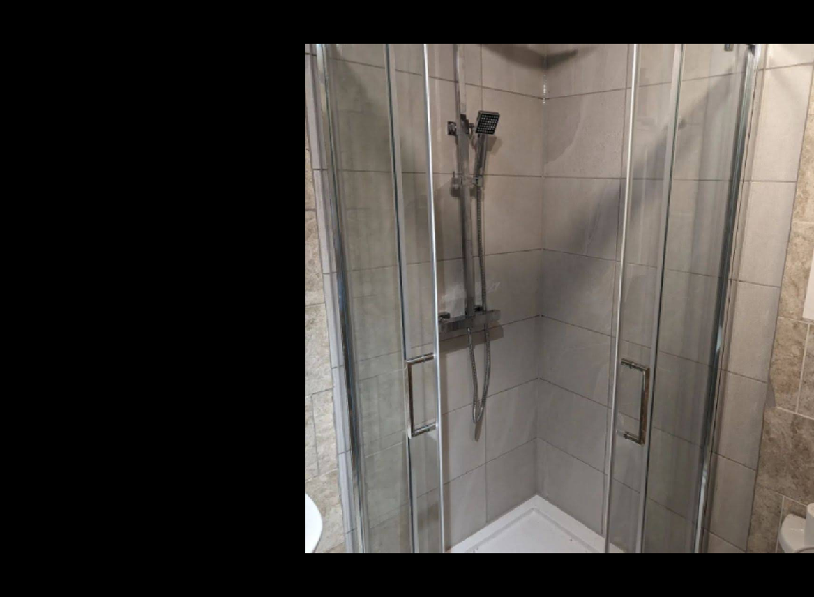 Grey tiled walk-in shower enclosure