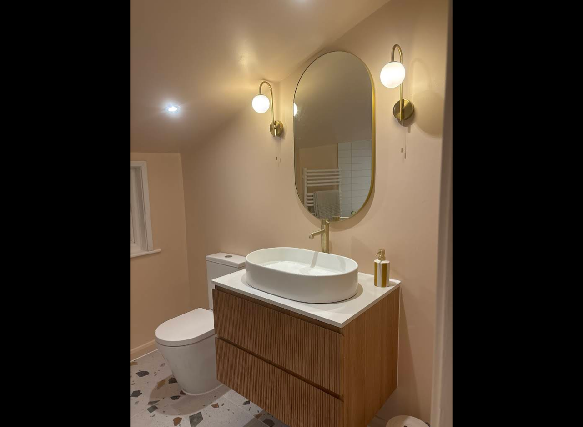 Luxury bathroom vanity with brass fixtures and warm wood tones