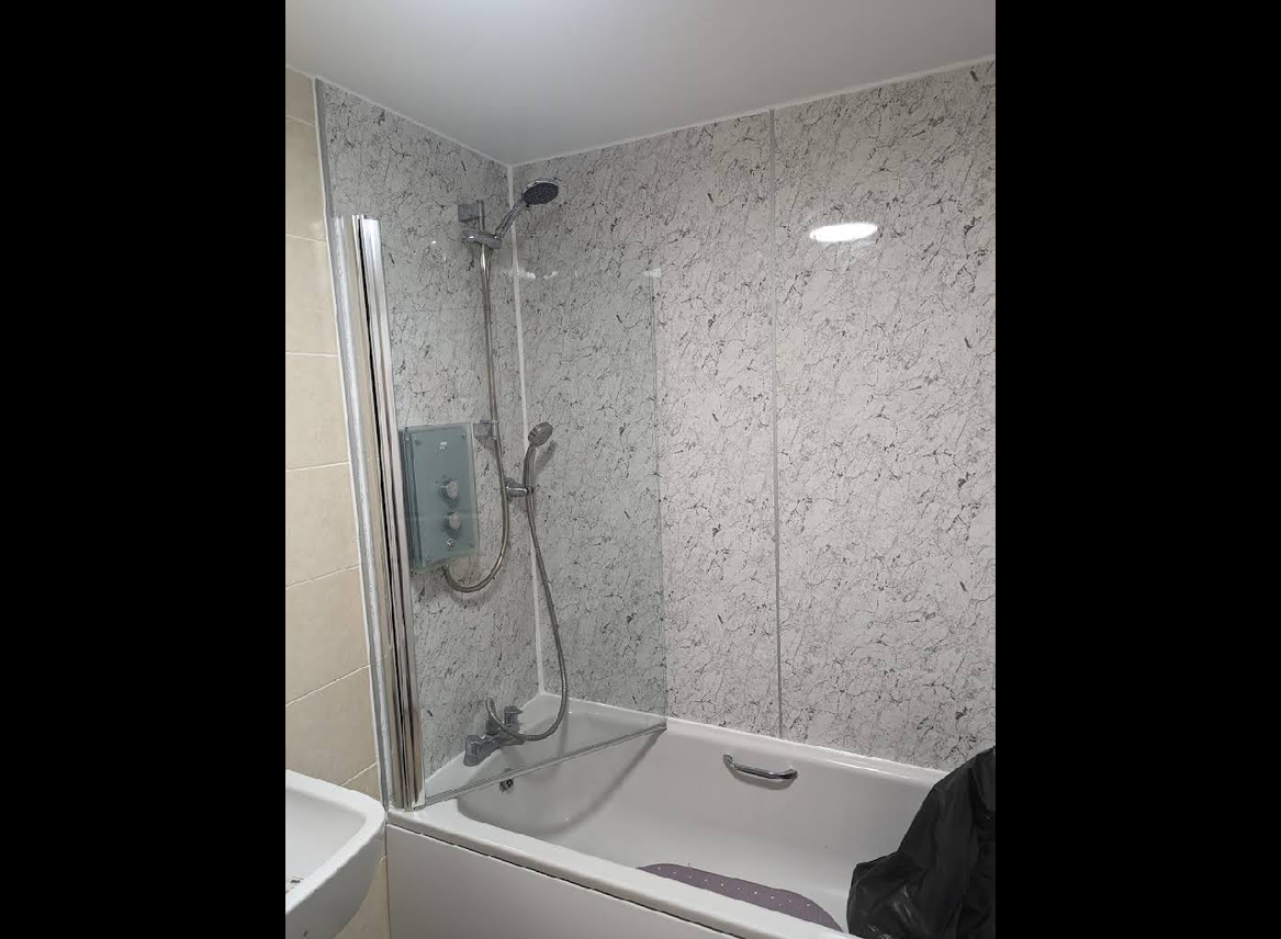 Marble effect panels with bath and shower screen